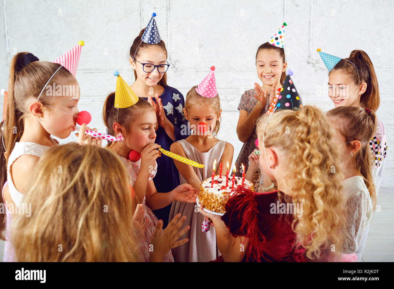 Children with a birthday cake have fun. Stock Photo