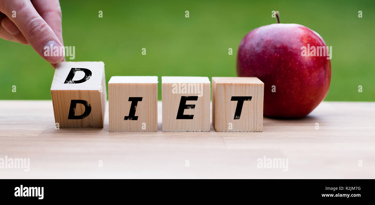 Dices form the word 'DIET' next to an apple Stock Photo