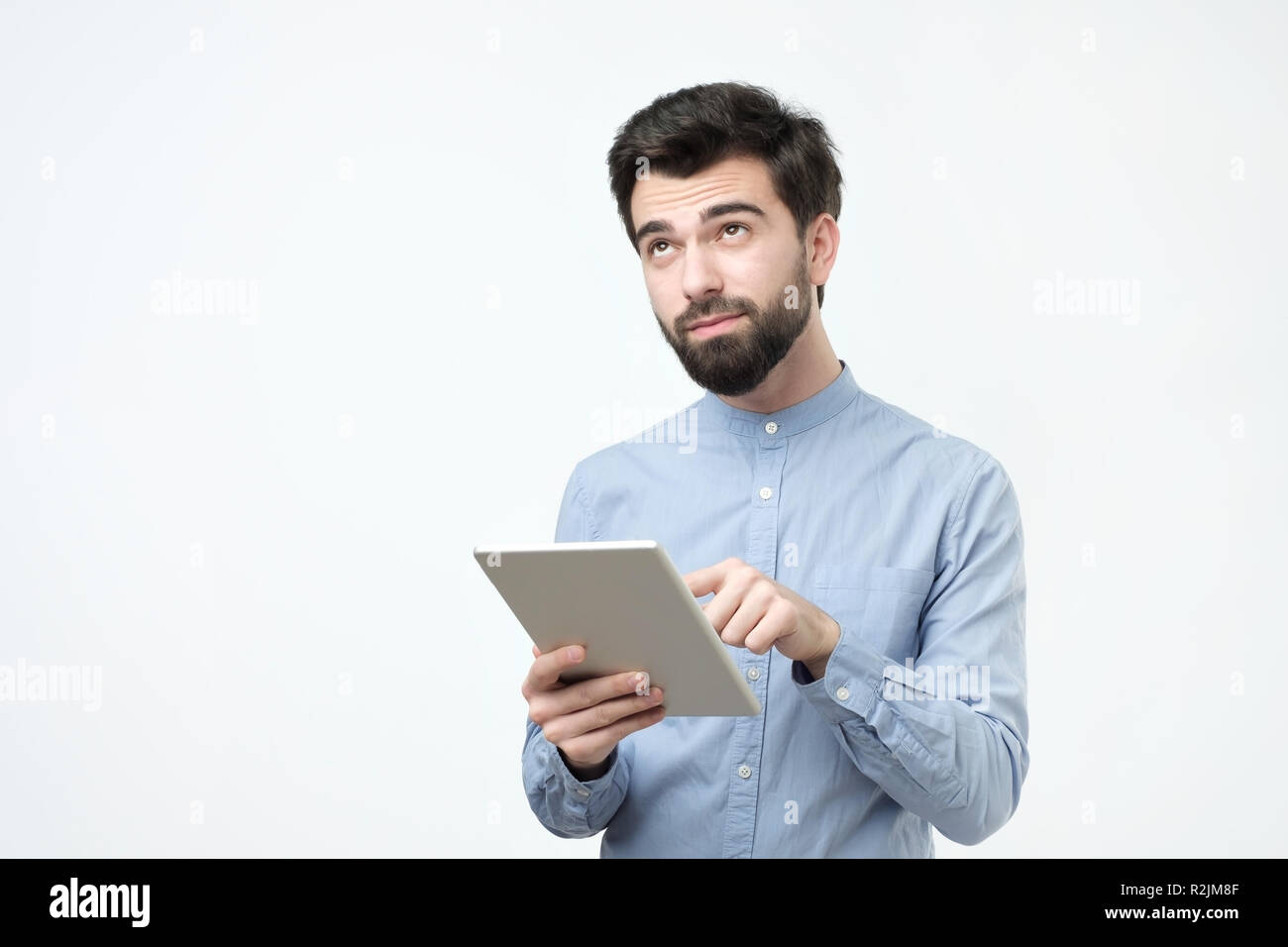 Handsome man using tablet on white background. Studio shoot Stock Photo