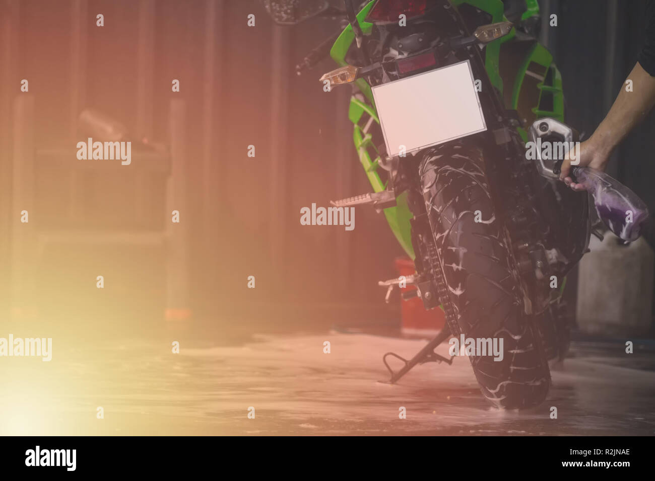 Motorcycle clean service. Employees are washing motorbikes Stock Photo