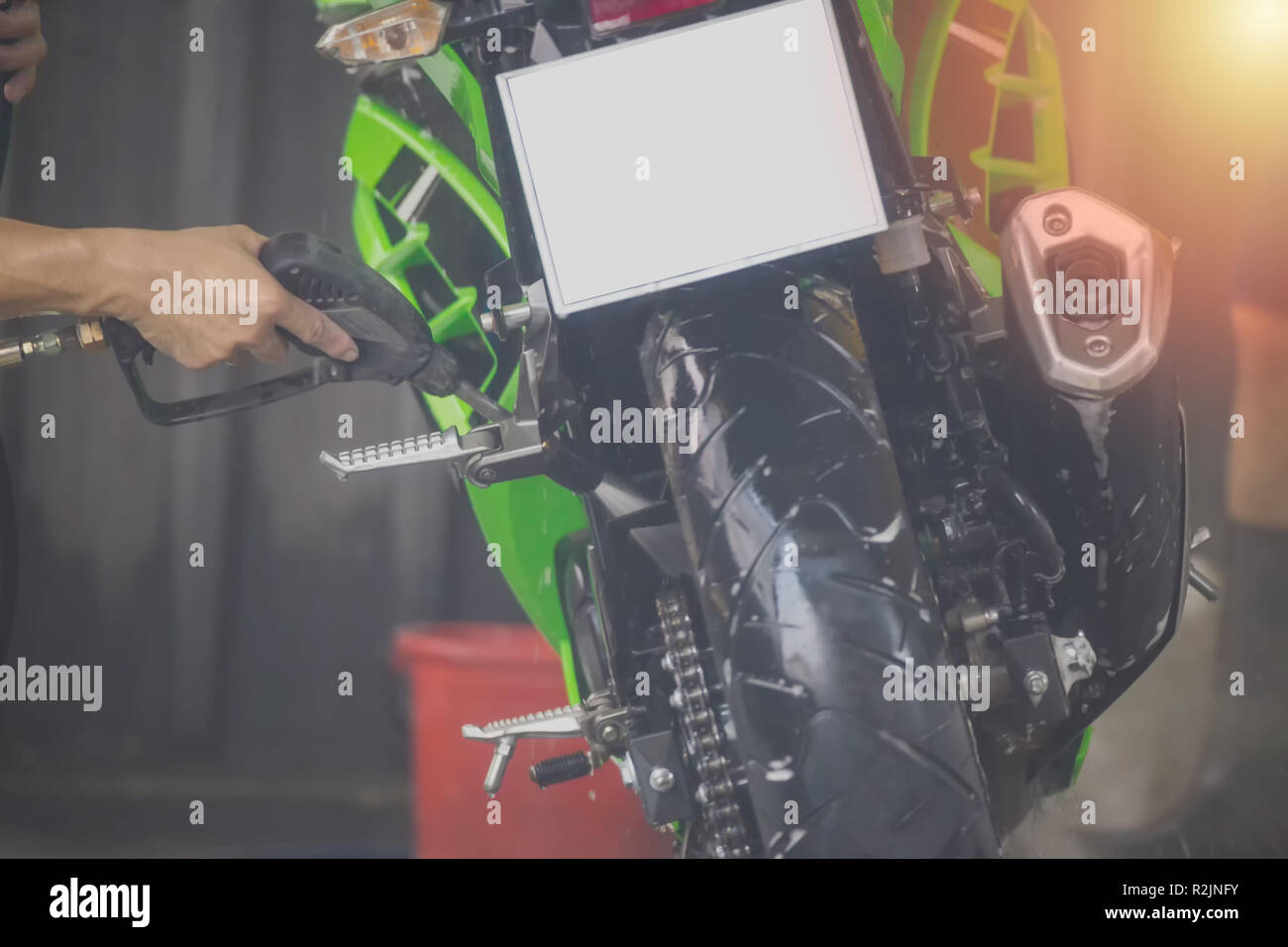 Motorcycle clean service. Employees are washing motorbikes Stock Photo