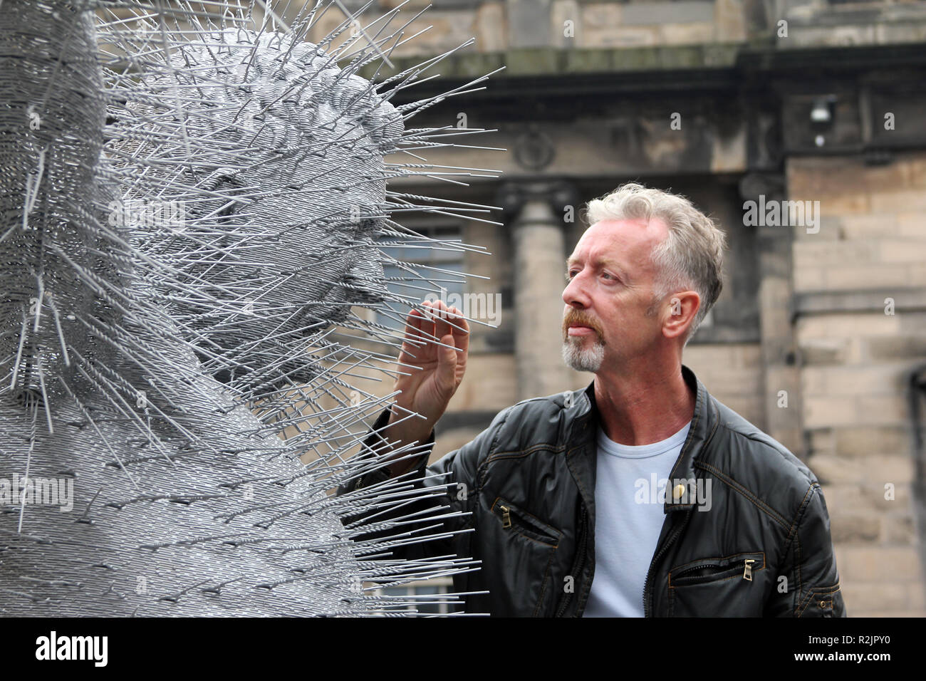 The Scottish artist, and Turner prize nominee, David Mach, makes a last minute adjustment to one of his coathanger sculptures before it is displayed outside St Giles Cathedral in Edinburgh 2010. Stock Photo