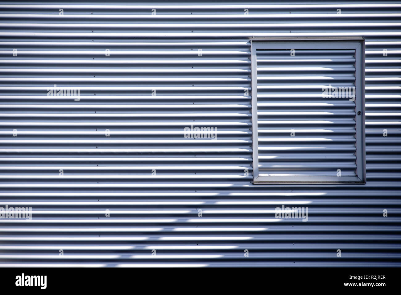 Detail of a modern corrugated sheet facade with a window frame Stock