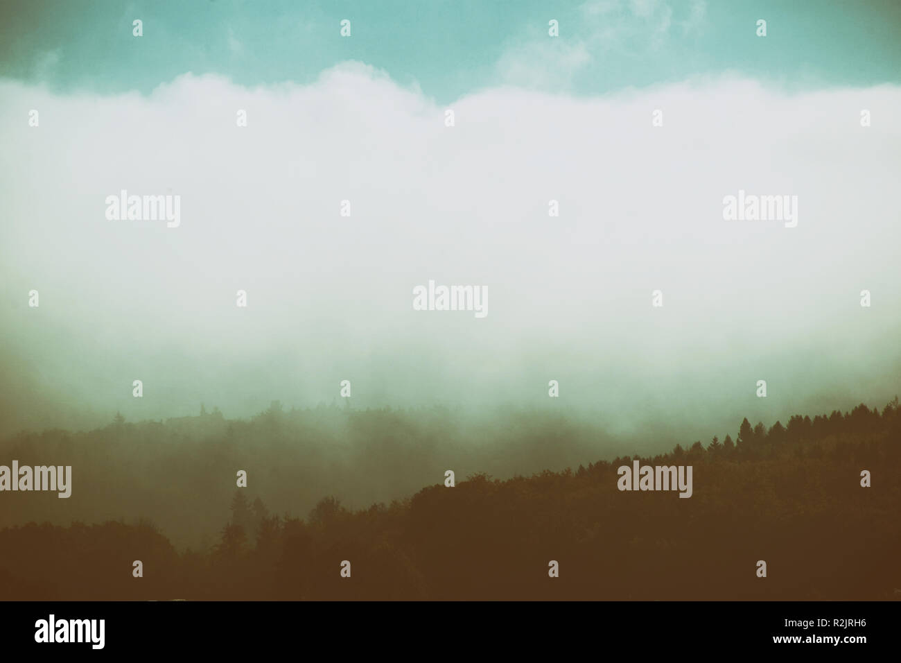 Wooded Ridges Clouds and ribbons of fog cross the wooded ridges of a mountain range ...