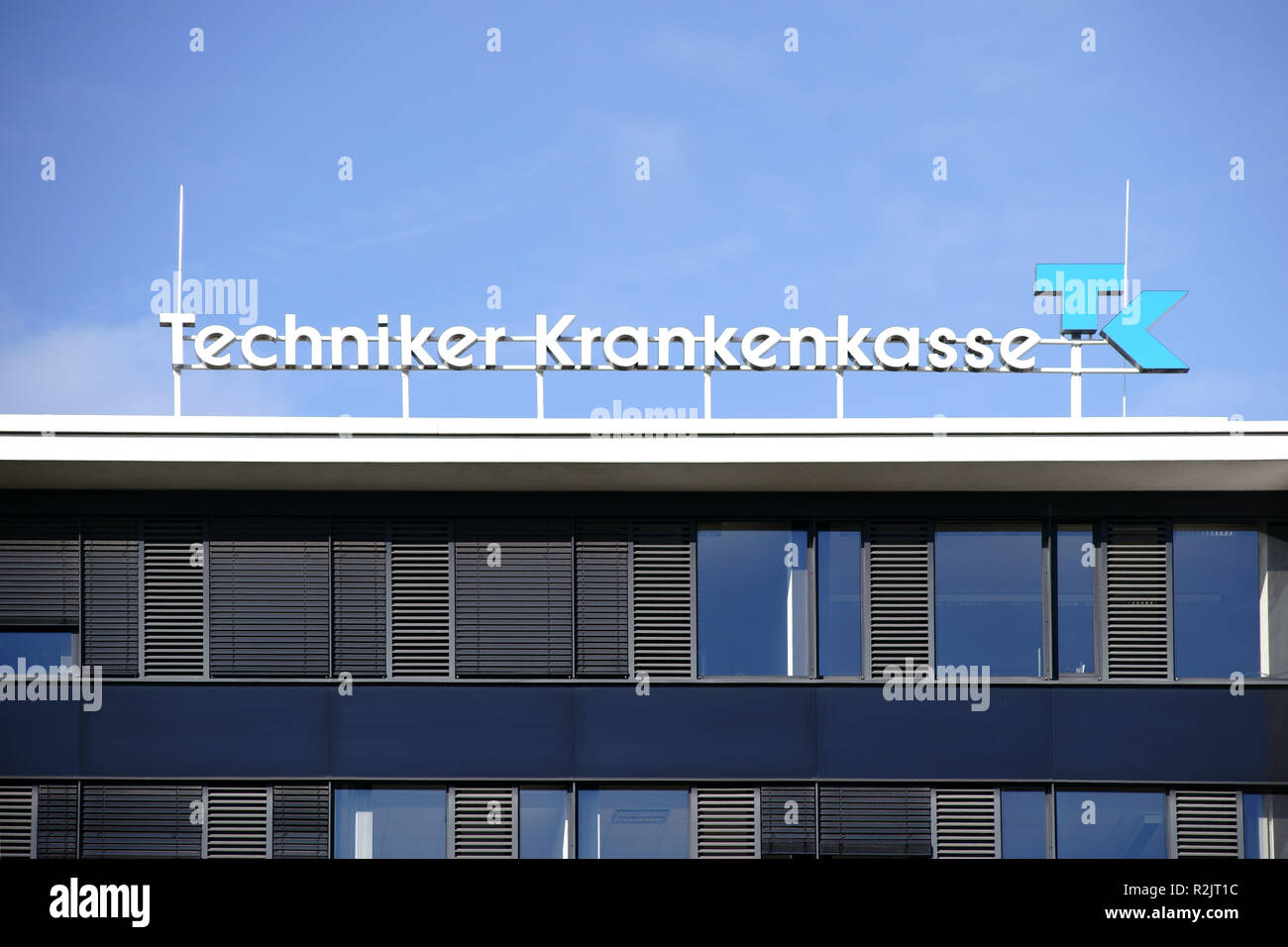 Facade of the modern office building of Techniker Krankenkasse TK with logo and office windows in Darmstadt, Stock Photo