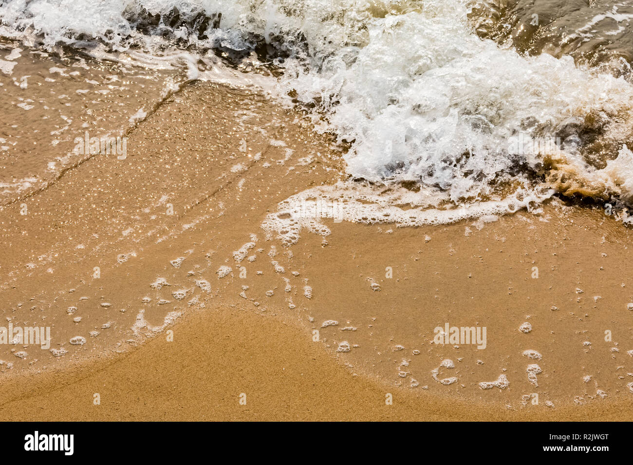 A beautiful pattern of sea water form after collide sea water wave at sea shore. Stock Photo