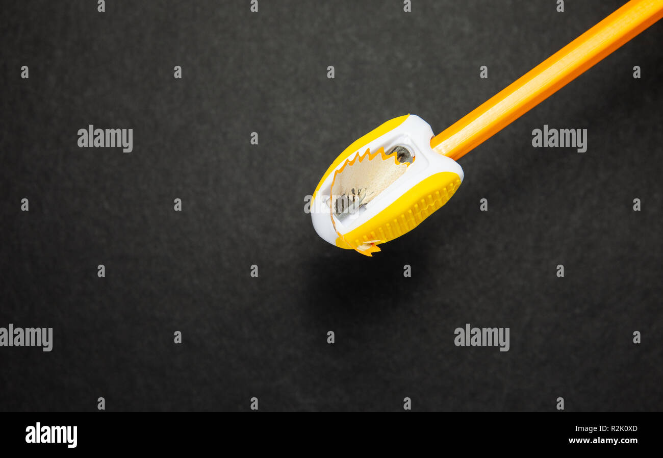 Pencil and sharpener on black background, top view Stock Photo