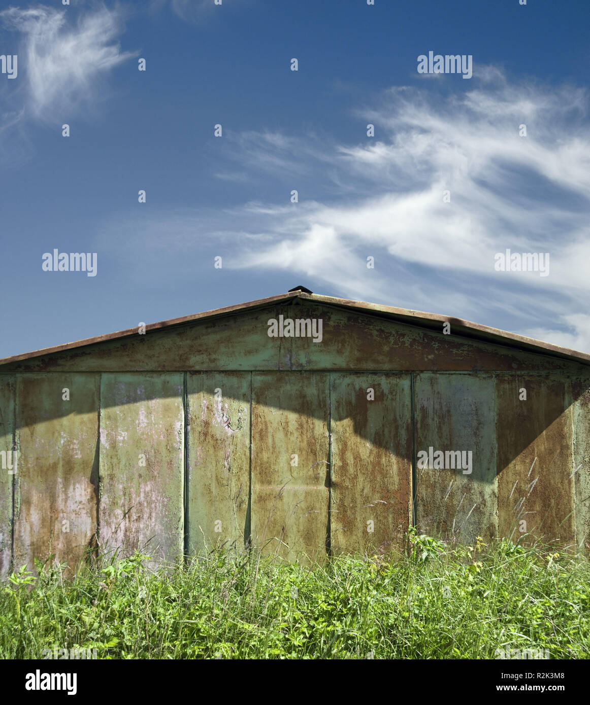 Old rusty barn, grass, cloudy sky, sunny day, Stock Photo