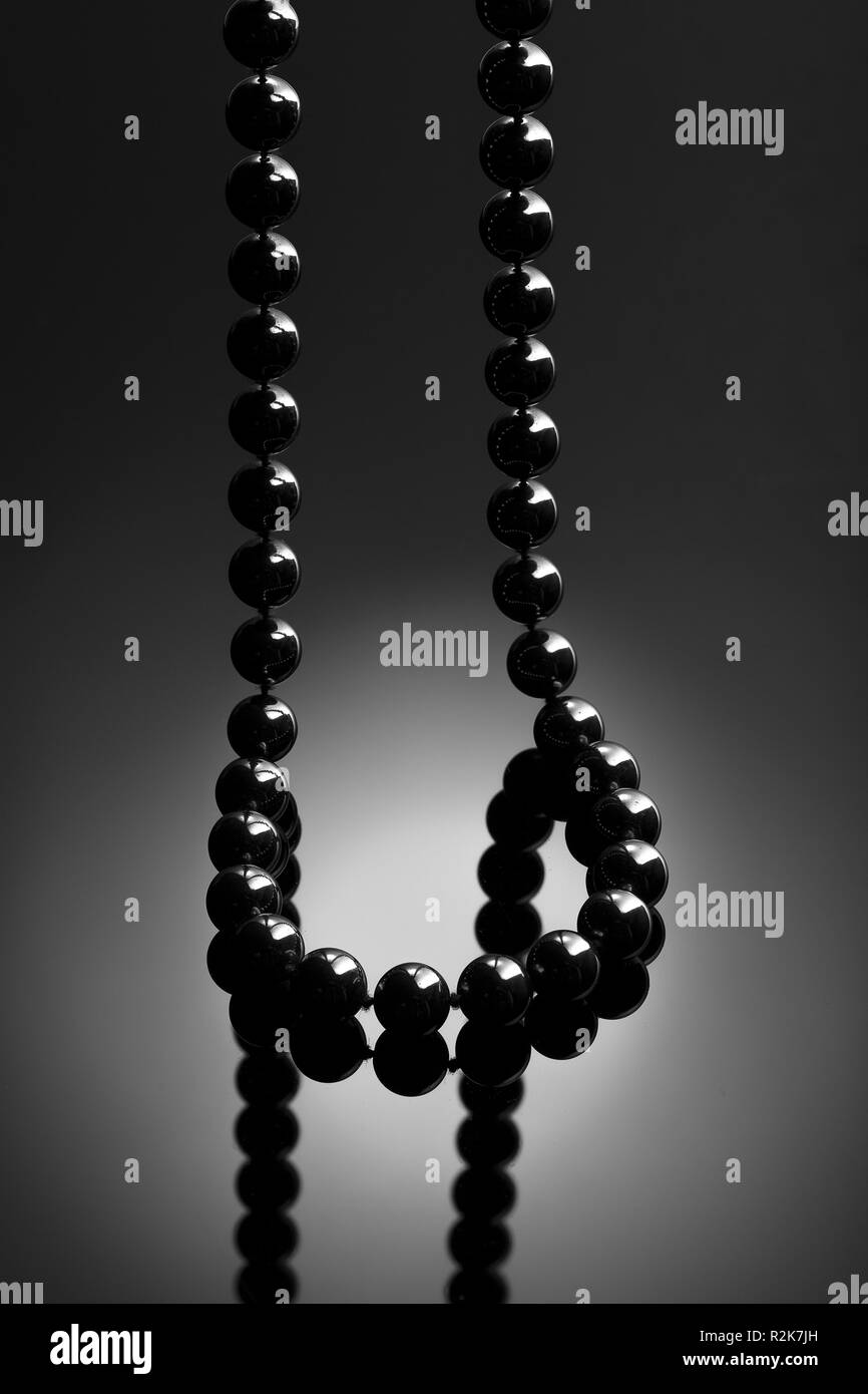 Black necklace on black background. Onyx necklace.  Jewelry concept Stock Photo
