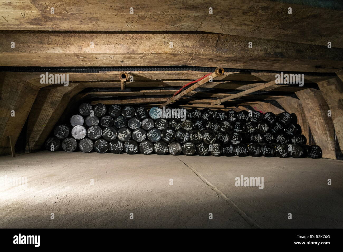 Radioactive waste package barrels in underground repository, terrorism pollution apocalypse concept Stock Photo