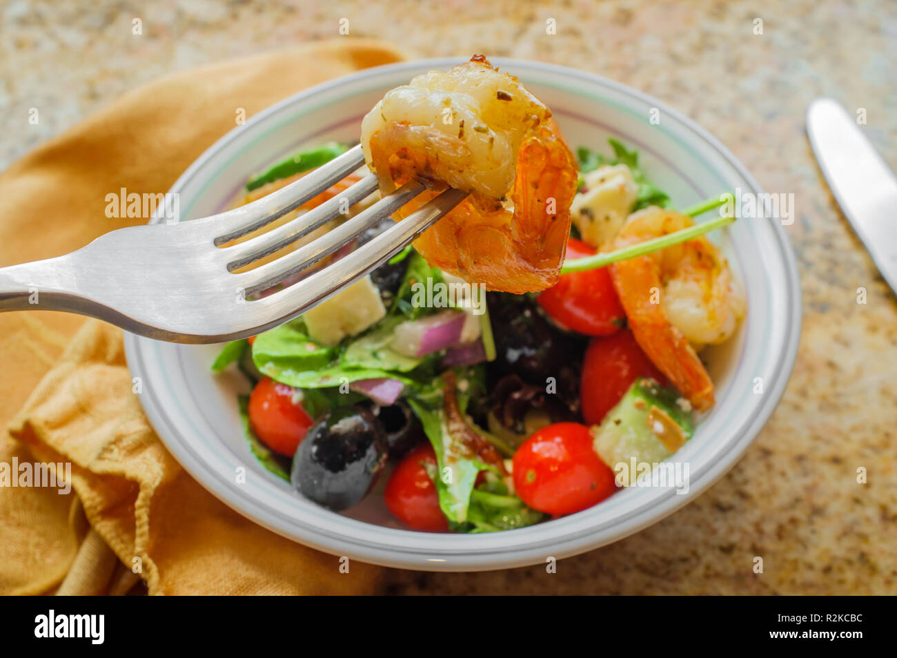 Fresh Greek salad with grilled shrimp and feta cheese with balsamic