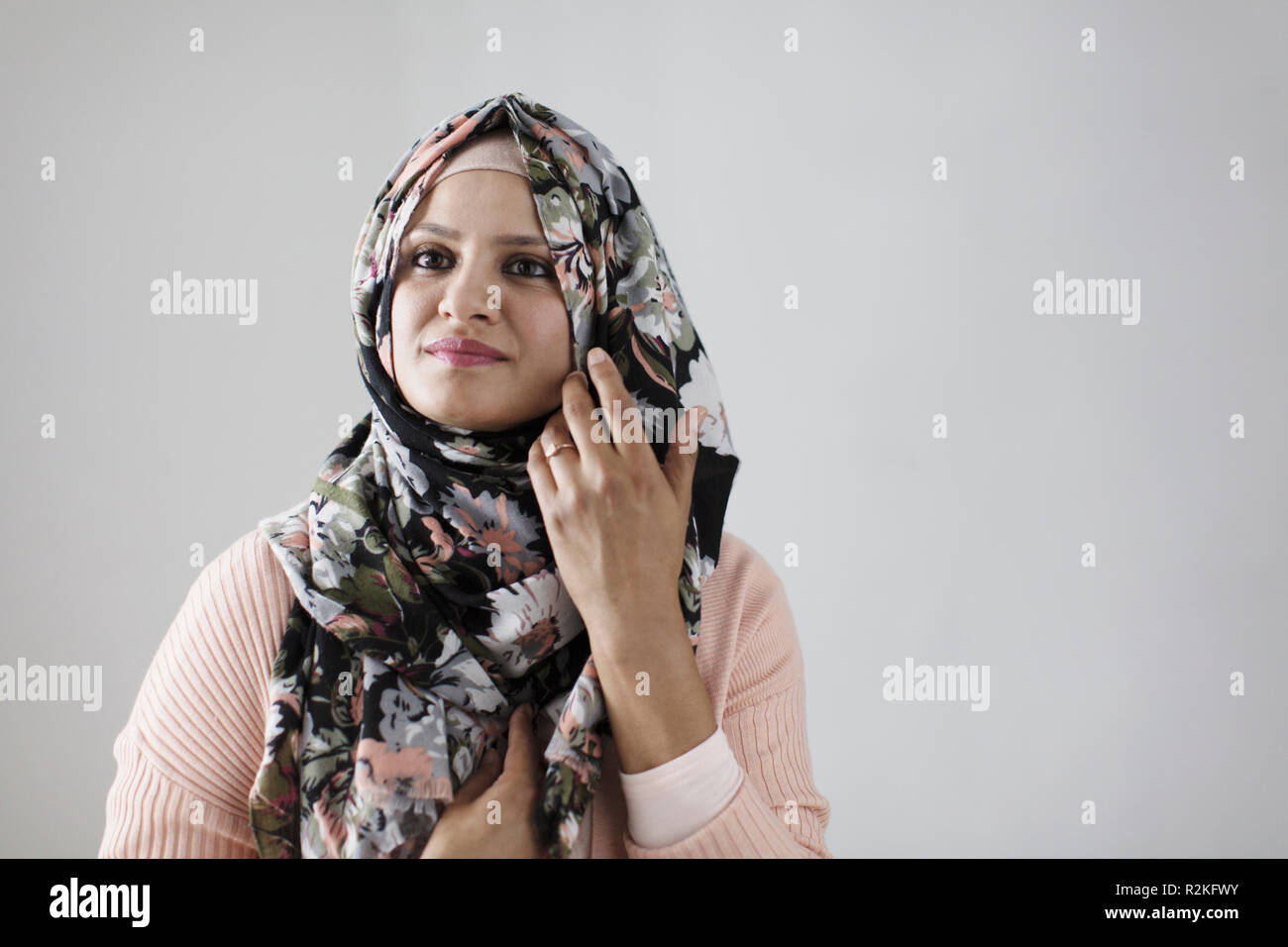 Portrait confident woman wearing floral hijab Stock Photo