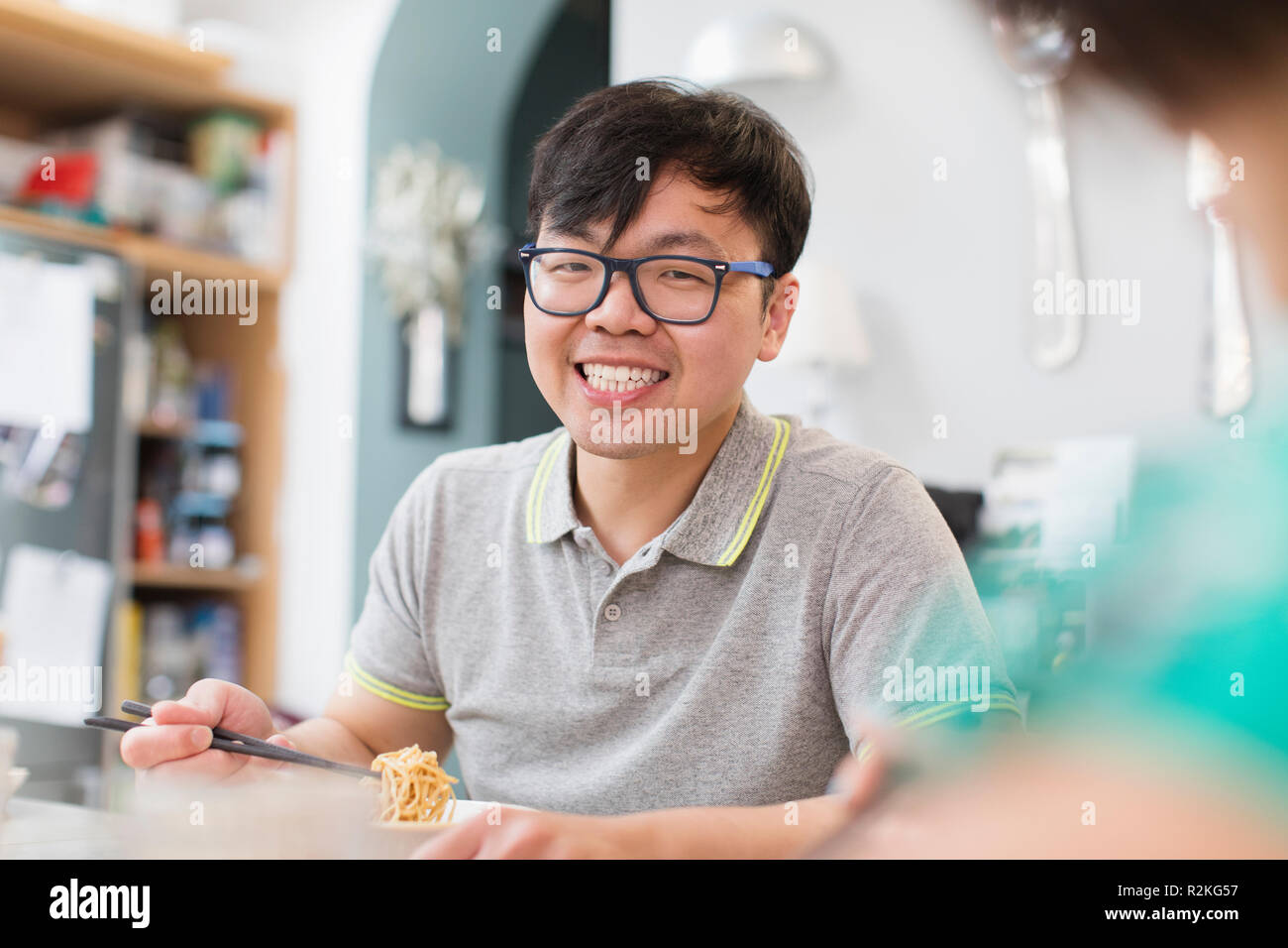 Portrait confident, smiling man eating noodles Stock Photo