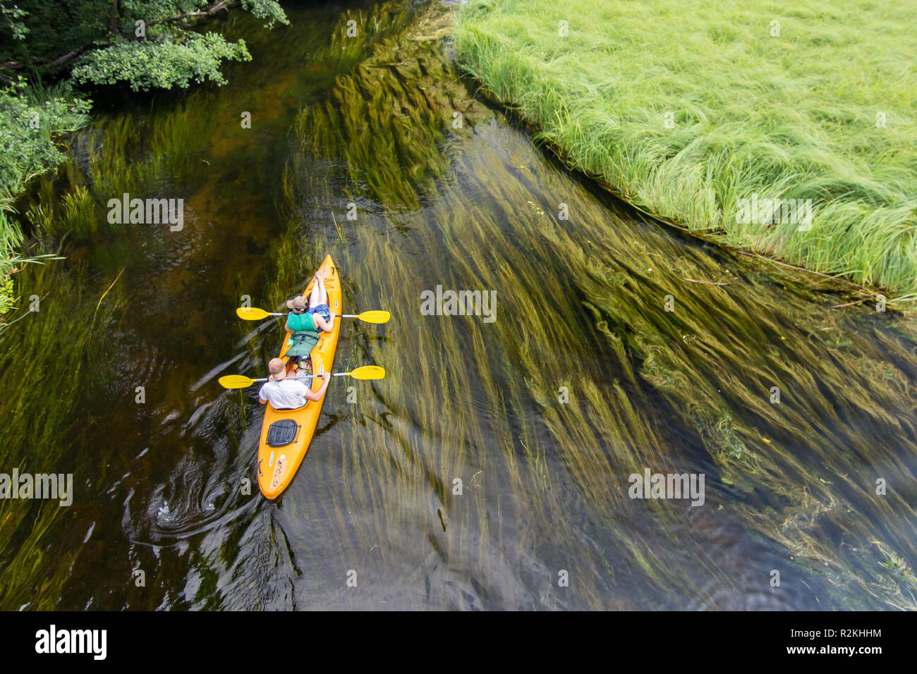 couple canoeing small slow river in eastern Poland, Czarna Hancza river, near Augustow Stock Photo