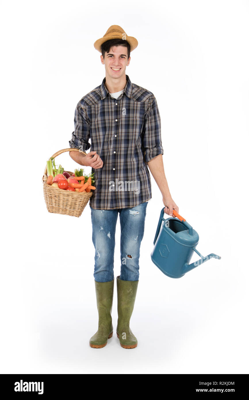 Young farmer with one arm holding a basket with fruit and vegetables ...