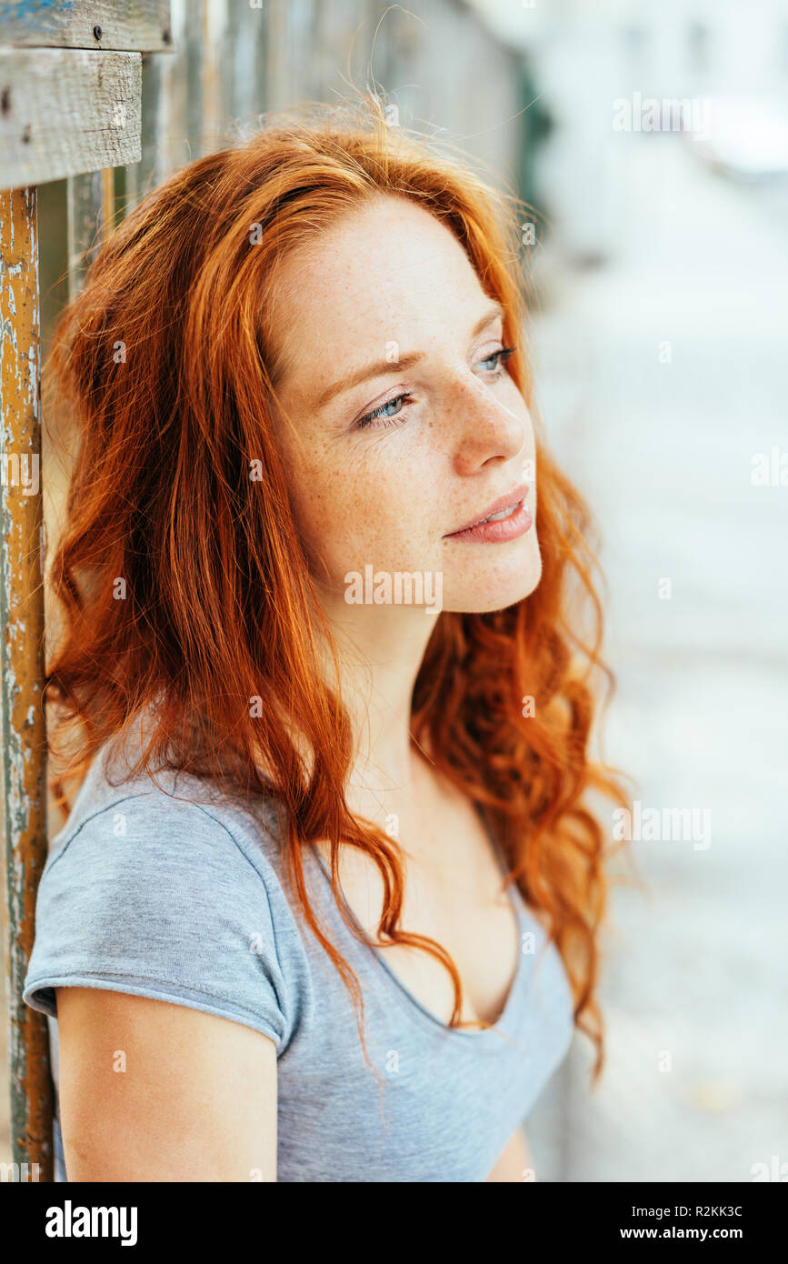 Single Calm Young Woman With Red Hair And Grey Short Sleeved Shirt