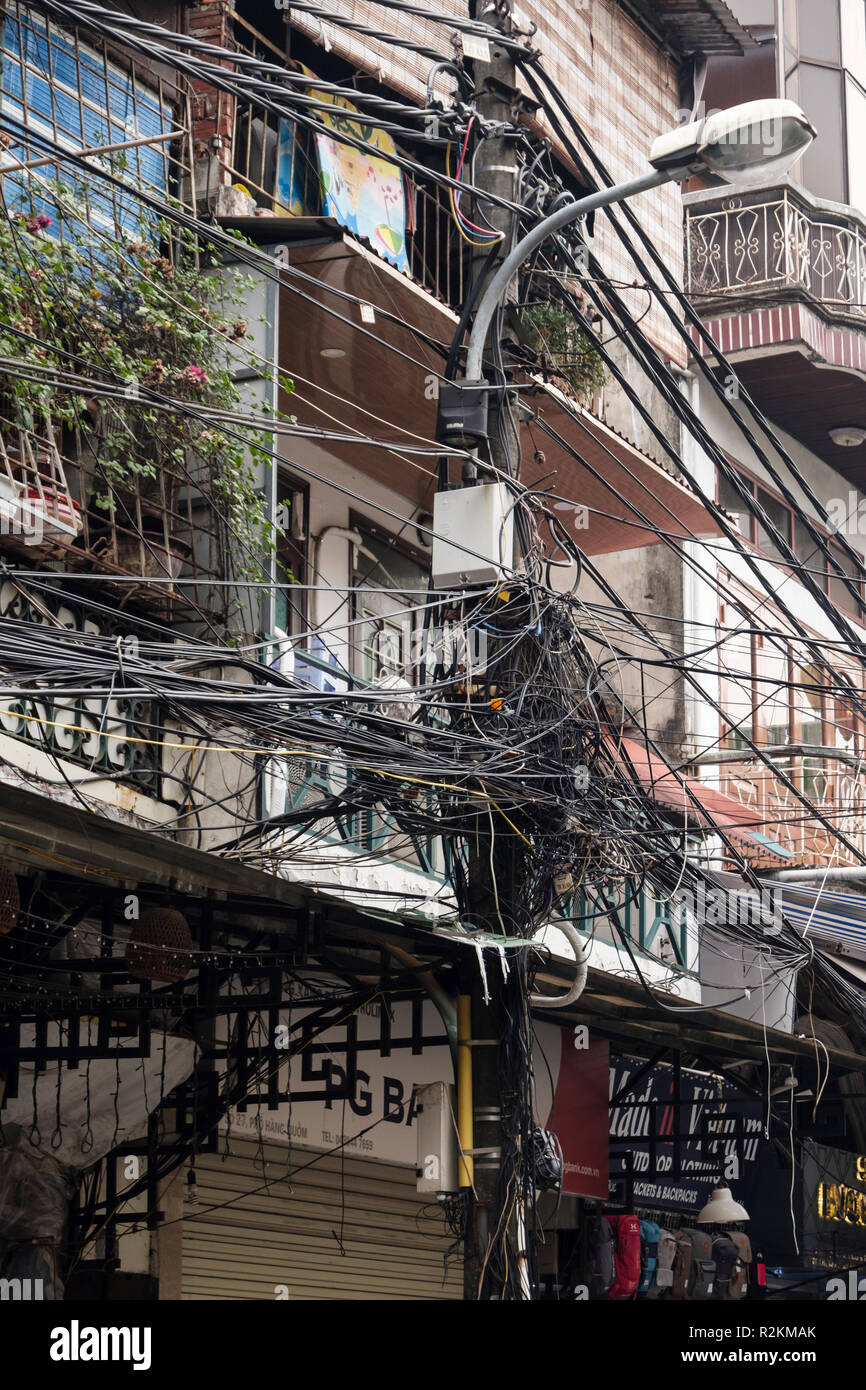 Chaotic electric wiring in a street in the old quarter of Hanoi, Vietnam, Asia Stock Photo