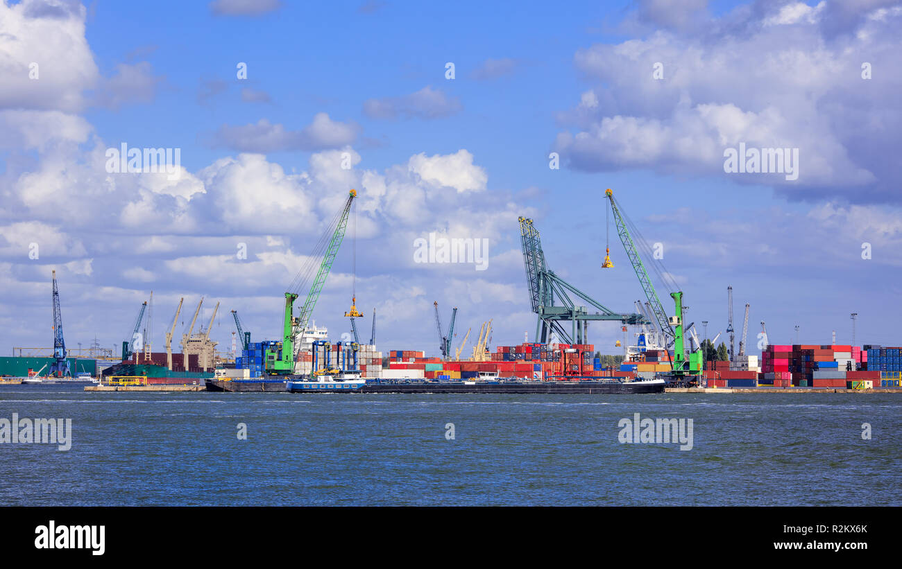 View on container terminal with massive cranes and stacked containers ...