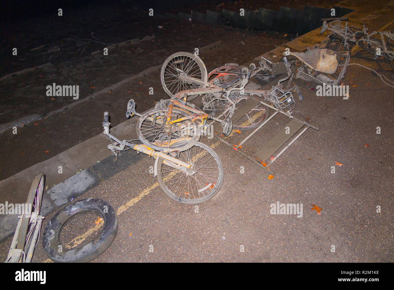 Collection of OFO bicycles dock less / dockless cycles / bike / Boris bikes which have been dredged up from the River Thames at Twickenham shown at night. UK Stock Photo