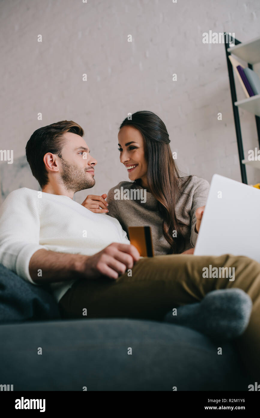 Bottom View Of Happy Young Couple Making E Shopping With Laptop On