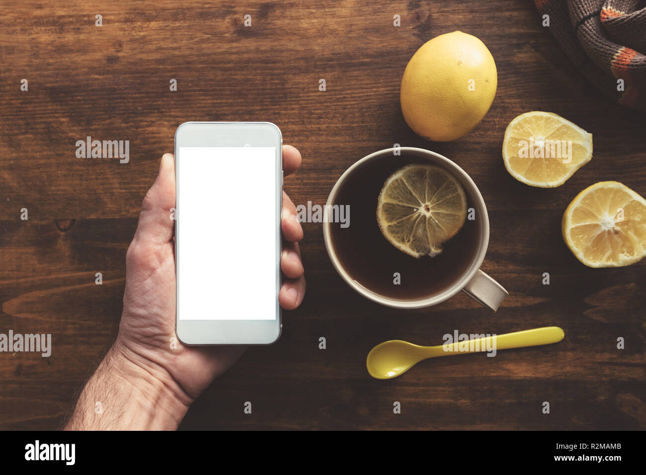 Using mobile phone and drinking tea, top view mock up copy space with ...