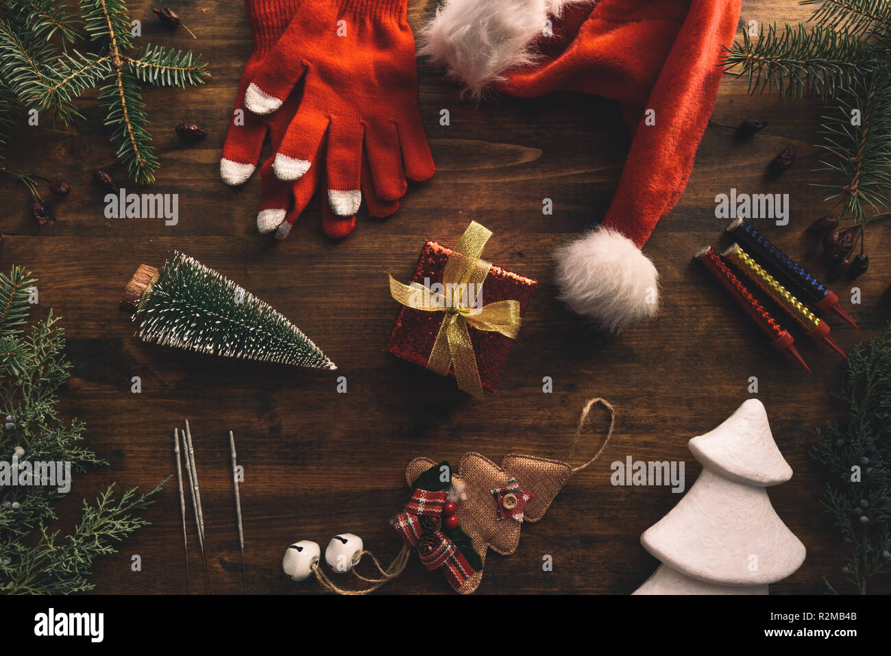 Nostalgic Christmas decoration flat lay arrangement with Santa Claus hat and gift box, top view Stock Photo