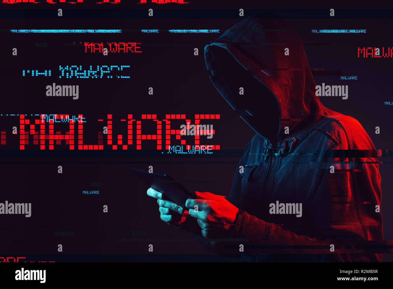 Malware concept with faceless hooded male person using tablet computer, low key red and blue lit image and digital glitch effect Stock Photo