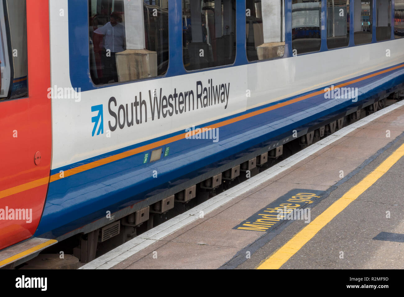 south western railway train in a platform at London waterloo station. mind the gap painted on the platform edge at railway station. commuting by rail. Stock Photo