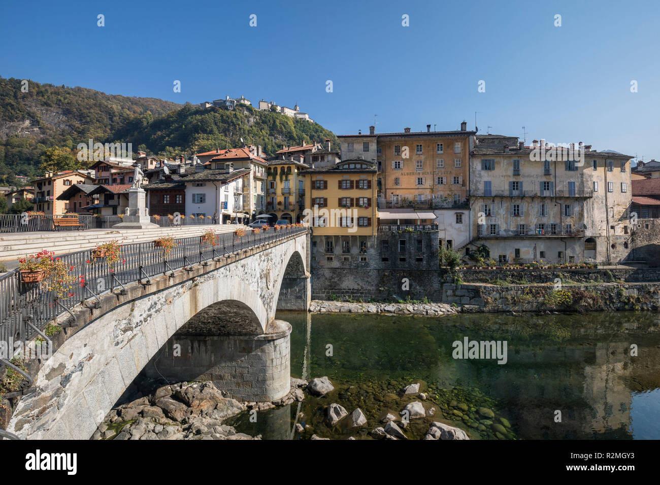 Bridge over the Sesia, old town of Varallo, behind the sacred mountain Sacro Monte di Varallo (UNESCO World Heritage since 2003), Varallo, province Vercelli, Piedmont, Italy Stock Photo