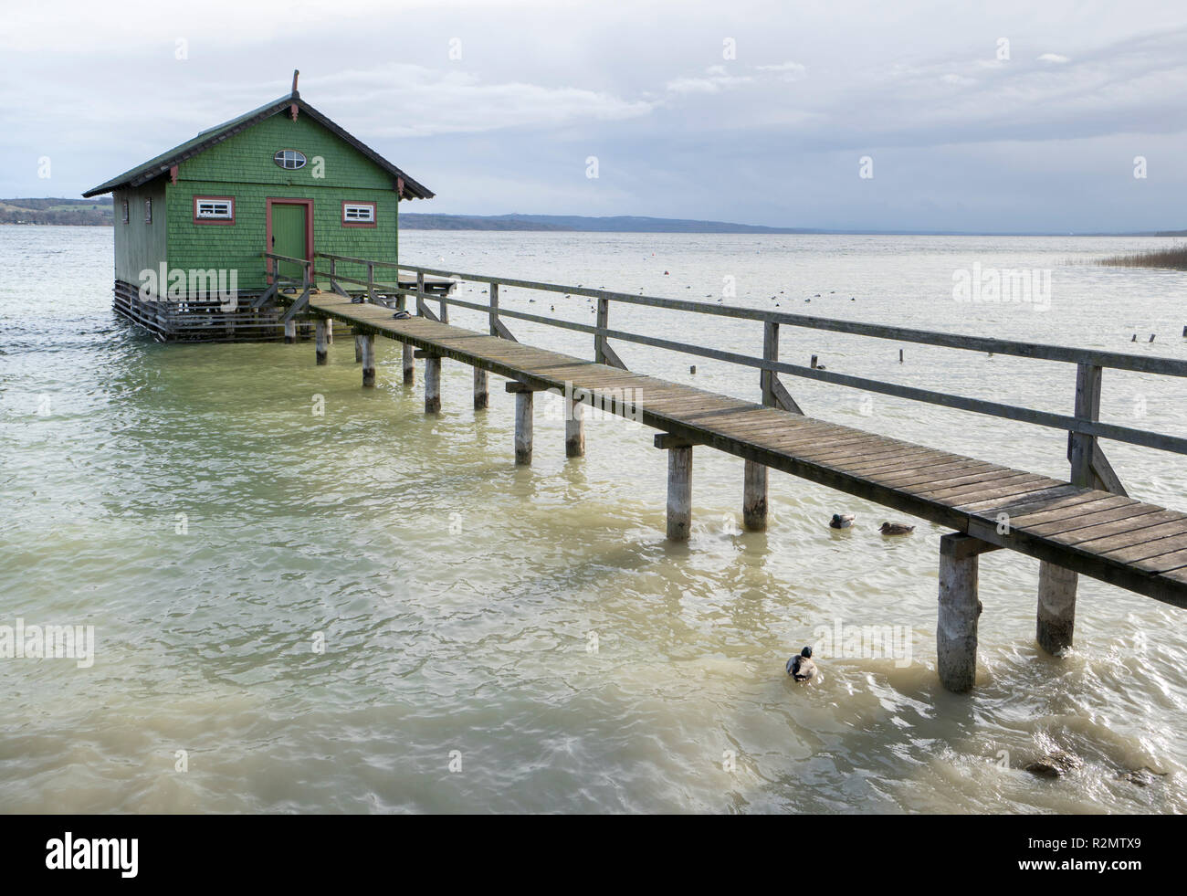 Old boat house with wooden pier at the Ammersee in Bavaria Stock Photo