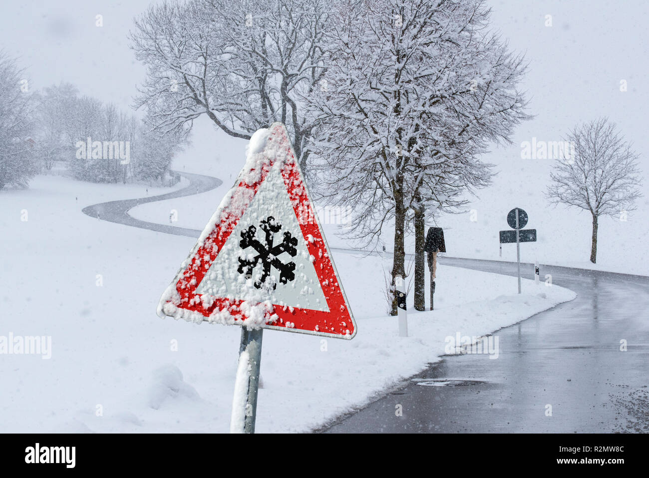 Warning sign of hard-packed snow on road Stock Photo