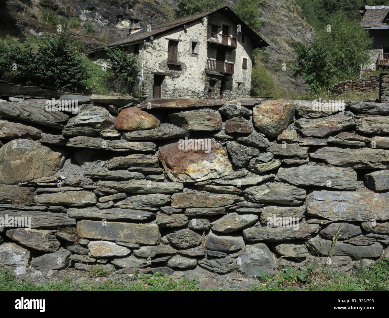 Old stone wall in the almost abandoned hamlet goal in the Spanish ...