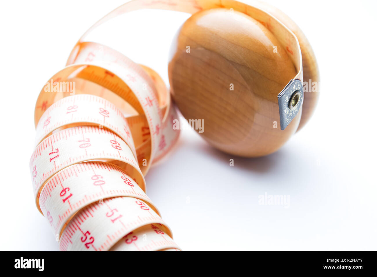 Yo-yo effect in diet concept. Wooden yoyo with centimeter measure ...