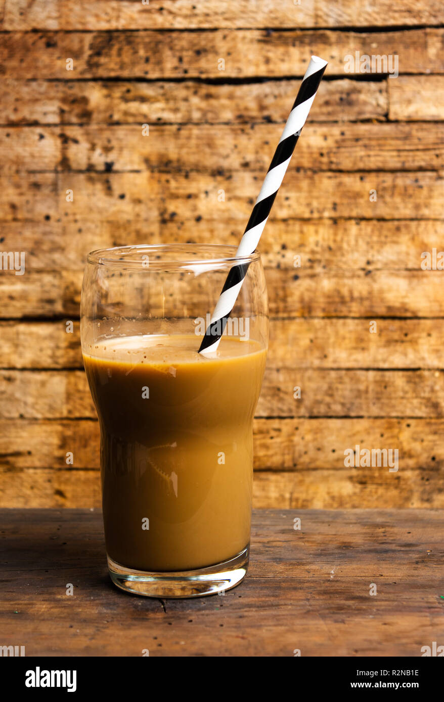 Iced coffee drink on glass jar with straw. Stock Photo by Civil