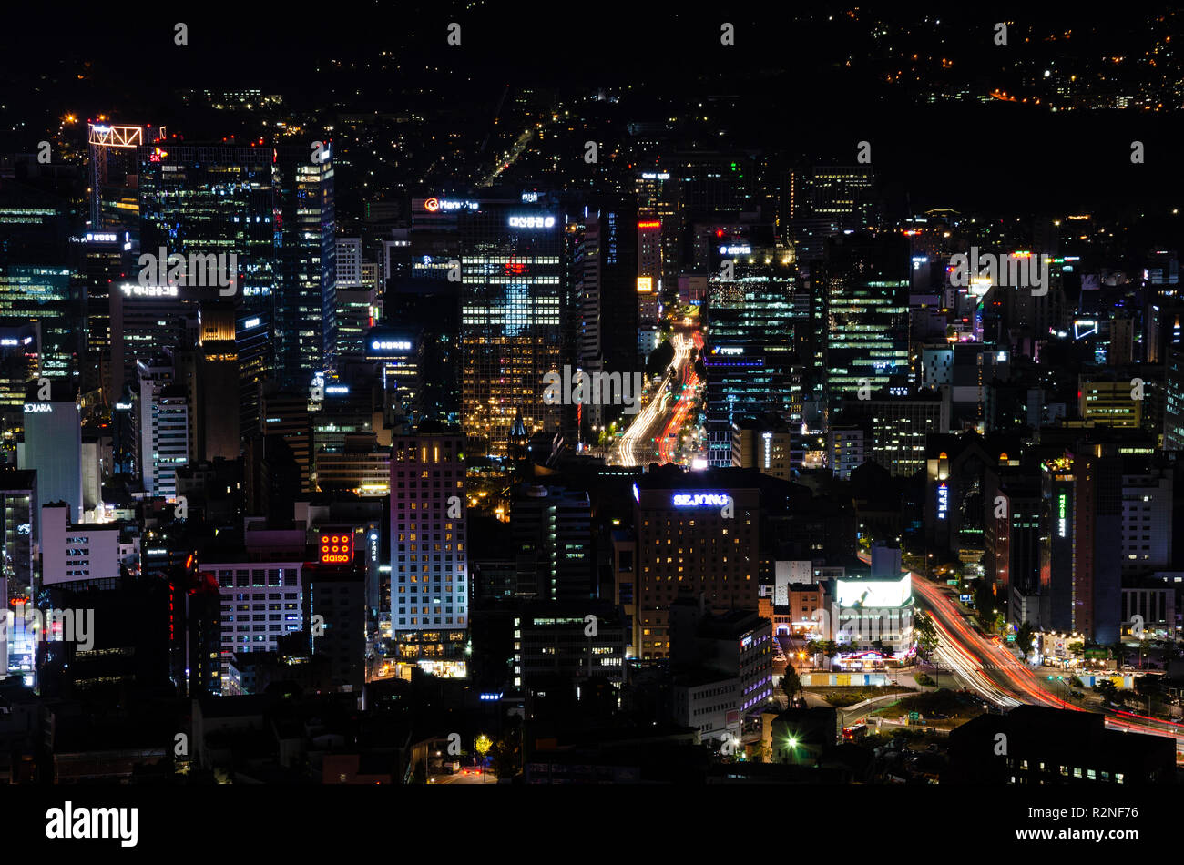 A view of the city of Seoul below at night, lit up with city lights taken form a high vantage point next to Namsan Tower. Seoul, South Korea. Stock Photo