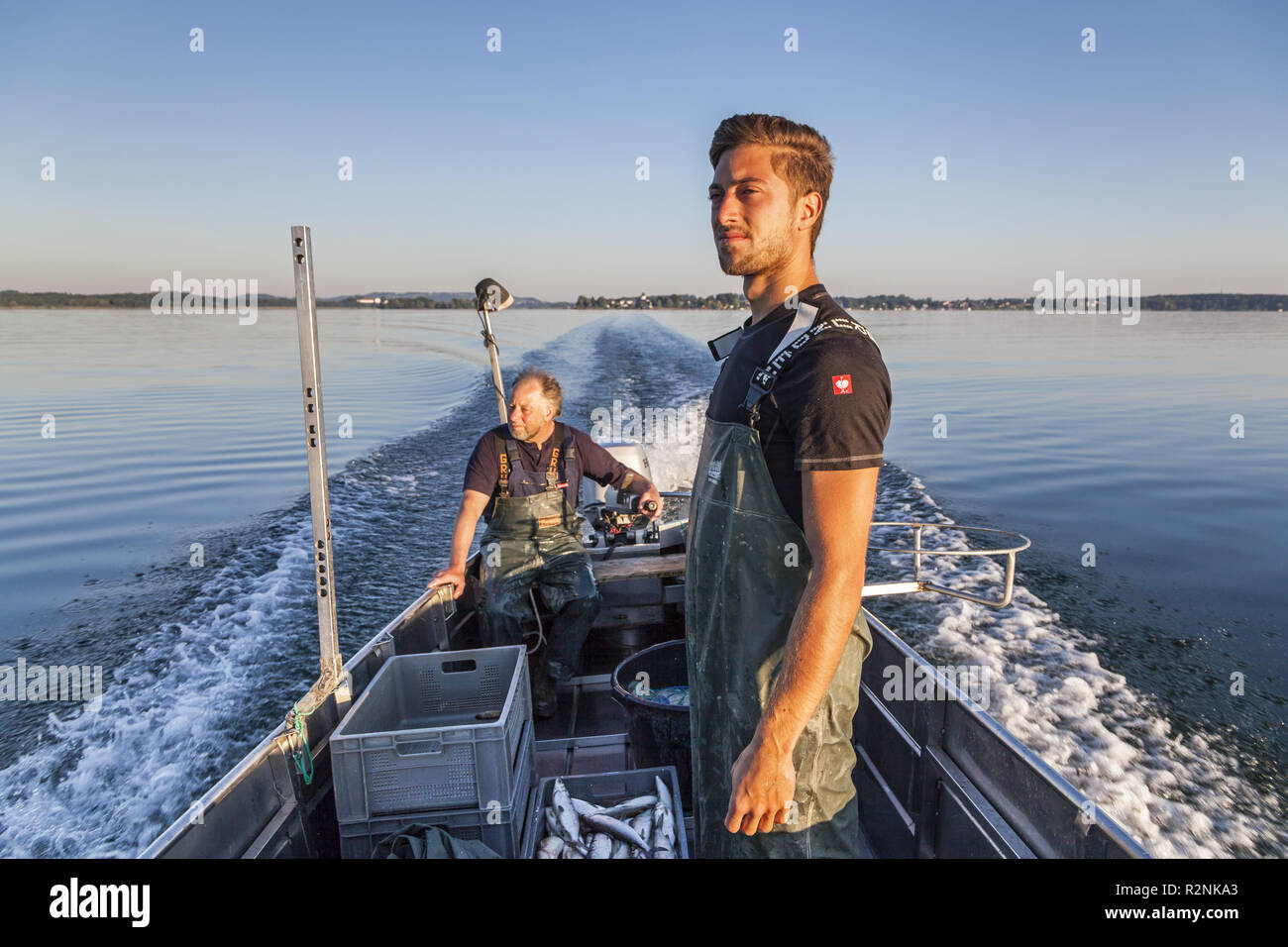 Man driving boat over lake hi-res stock photography and images - Alamy