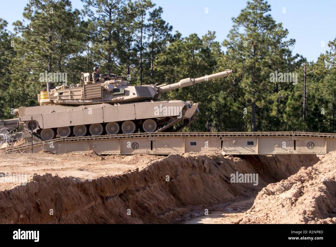 South Carolina Army National Guard Soldiers from 4th Battlion, 118th Regiment and 174th Engineer Company conduct combined arms breaching exercises at McCrady Training Center, Eastover, S.C., Nov. 3, 2018.  The 4th Battalion infantry companies practiced attacking an objective using support from the 174th engineer mobility assault platoons for obstacle reduction, destruction and short-gap crossings.  The combined forces breached wired obstacles using simulated M58 Mine Clearing Line Charge (MICLIC) rockets, cleared minefields with an M9 Armored Combat Earthmover (ACE), and placed a bridge over a Stock Photo