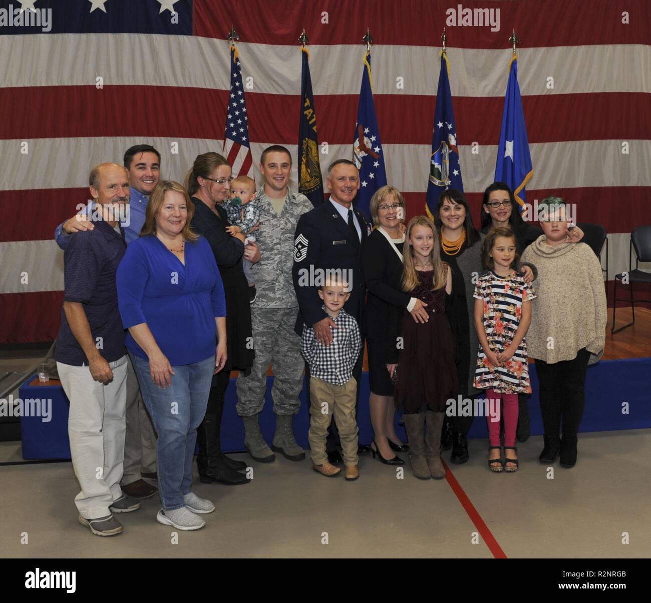 Oregon Air National Guard Chief Master Sgt. Mark W. McDaniel, the newly appointed State Command Chief Master Sgt. for the Oregon Air National Guard, pauses for a photo with his family following the Change of Authority ceremony held Nov. 4, 2018, at the Anderson Readiness Center, Salem, Oregon. The Change of Authority ceremony acknowledges the transfer of authority from the outgoing and incoming Command Chief Master Sergeant for the Oregon Air National Guard, State of Oregon. Stock Photo