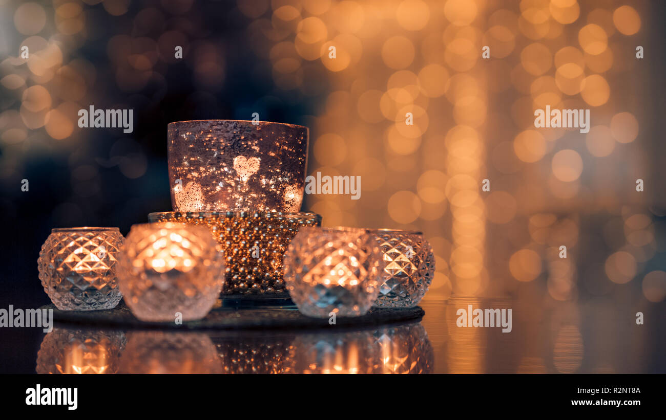 Cozy home interior decor, burning candles in glasses with blurred romantic  lights background. Christmas or winter season autumn home interior Stock  Photo - Alamy