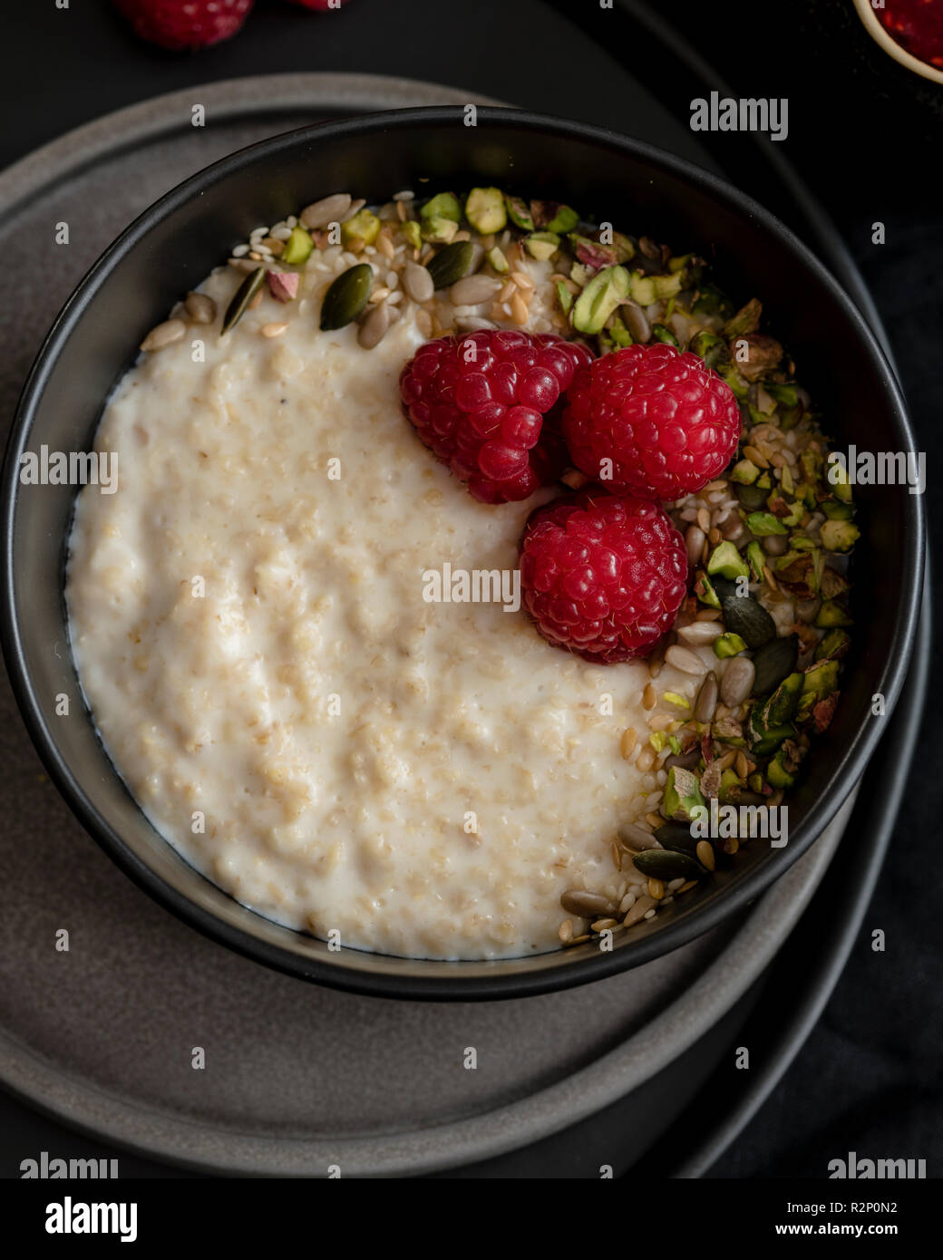 Porridge with fruity sauce and pistachio hires stock photography and