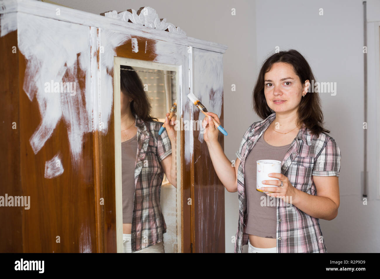 Creative Woman Is Decorating Old Wardrobe With White Paint At The