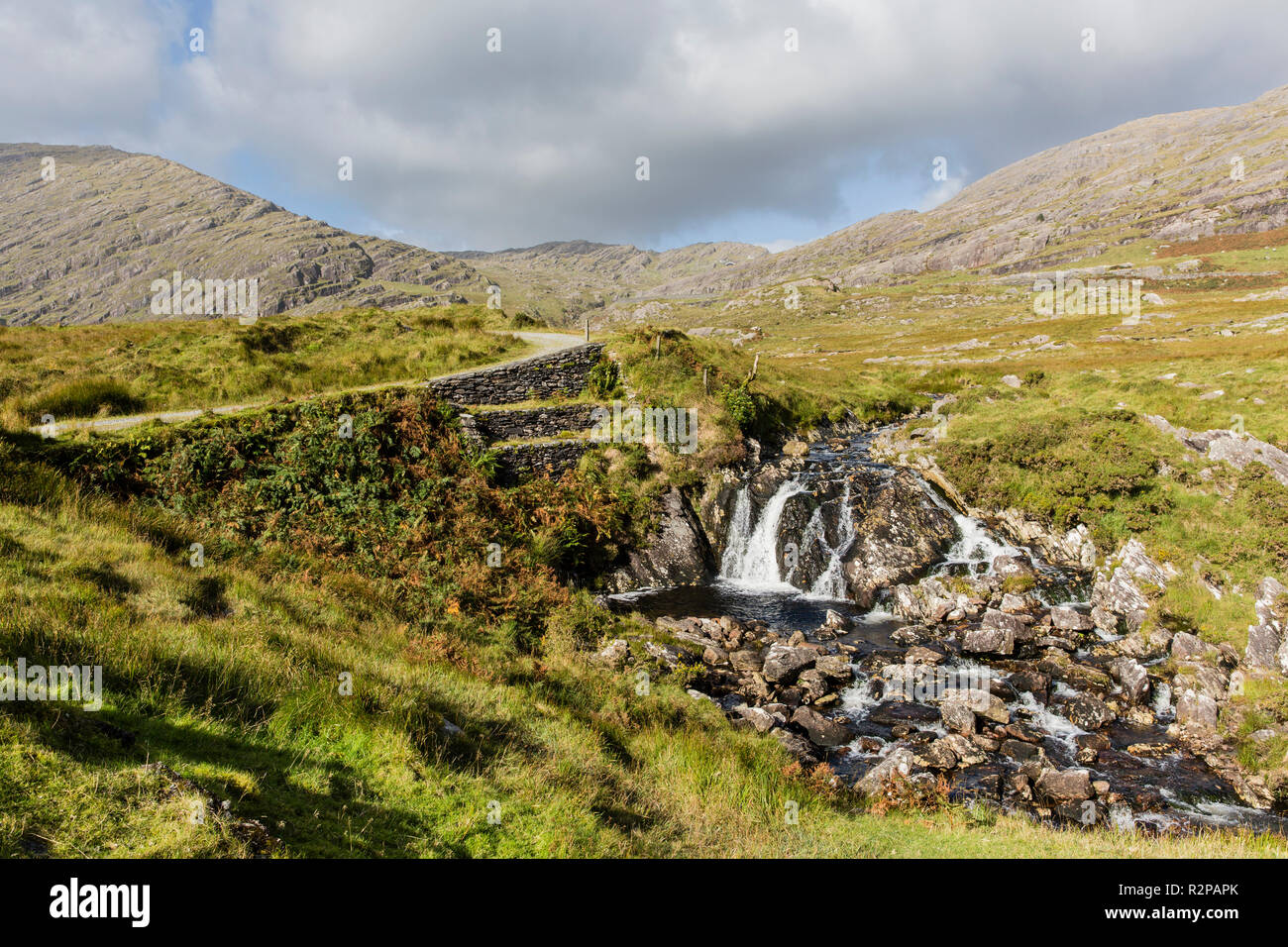 Waterfall in the Caha Mountains on Beara Peninsula in the southwest of Ireland, lush vegetation Stock Photo