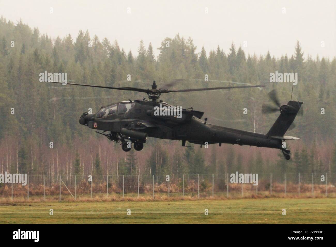 A U.S. Army Apache helicopter assigned to the 1st Battalion, 3rd Aviation Regiment, 12th Combat Aviation Brigade returns to Rena Leir Airfield, Norway, during Trident Juncture 18, Nov. 1, 2018. Trident Juncture is a NATO-led military exercise held in Norway. The exercise is the largest of its kind in Norway since the 1980s. An expected 51,000 participants from over 30 nations will take part, including 10,000 vehicles, 150 aircraft and 60 vessels. The main goals of Trident Juncture is to train the NATO Response Force and to test the alliance's defense capabilities. Stock Photo