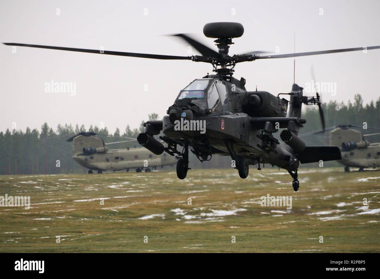 A U.S. Army Apache helicopter assigned to the 1st Battalion, 3rd Aviation Regiment, 12th Combat Aviation Brigade returns to Rena Leir Airfield, Norway, during Trident Juncture 18, Nov. 1, 2018. Trident Juncture is a NATO-led military exercise held in Norway. The exercise is the largest of its kind in Norway since the 1980s. An expected 51,000 participants from over 30 nations will take part, including 10,000 vehicles, 150 aircraft and 60 vessels. The main goals of Trident Juncture is to train the NATO Response Force and to test the alliance's defense capabilities. Stock Photo