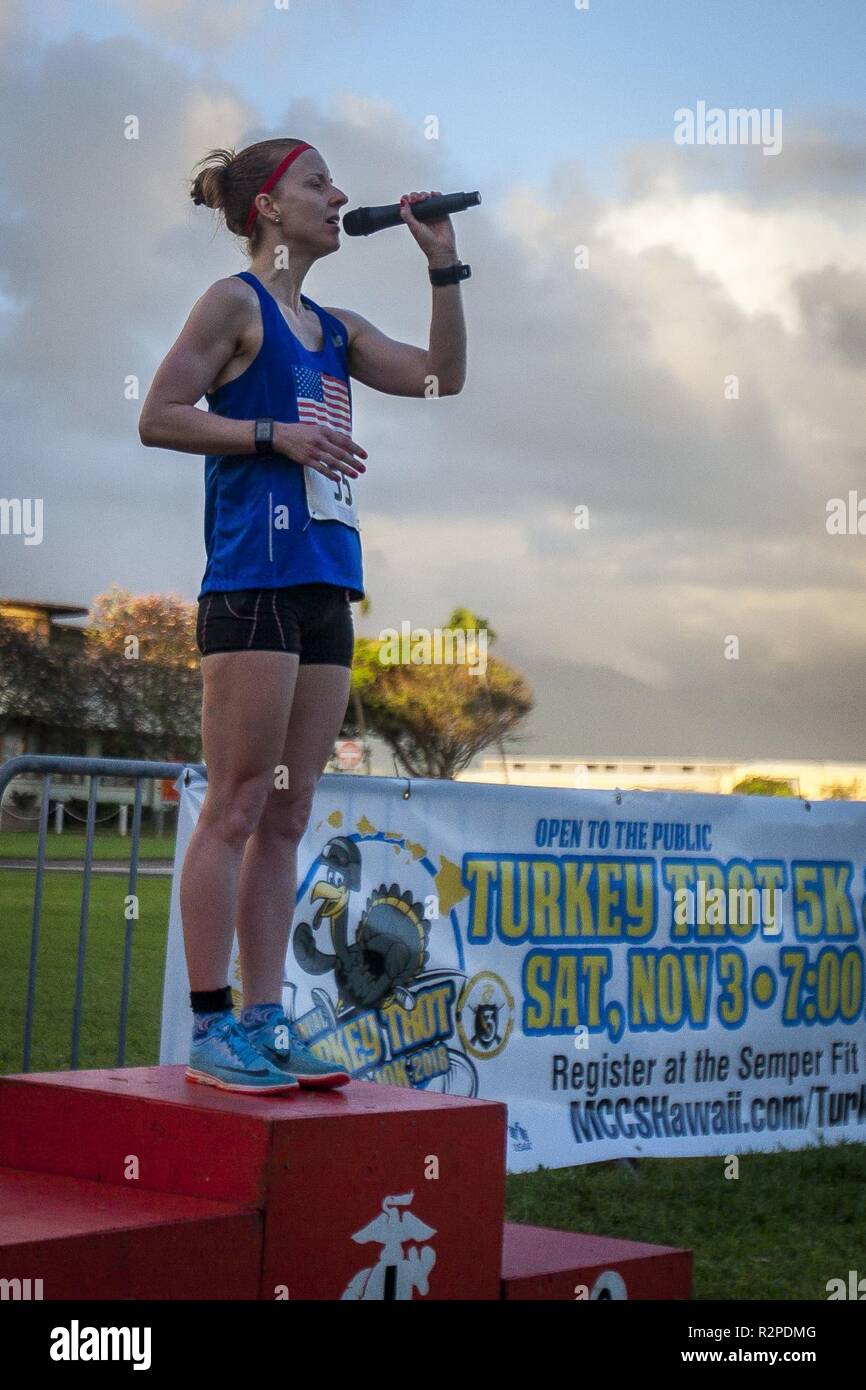 A contestant sings the national anthem prior to the Turkey Trot 5k and 10k run, Marine Corps Base Hawaii, Nov. 3, 2018. The event, hosted by 3rd Radio Battalion and Marine Corps Community Services Hawaii, is an annual Thanksgiving-themed event that is open to U.S. Service members, their families, and civilian participants. The event promotes readiness and resiliency across the installation and local community by encouraging healthy, family-oriented activity. Stock Photo