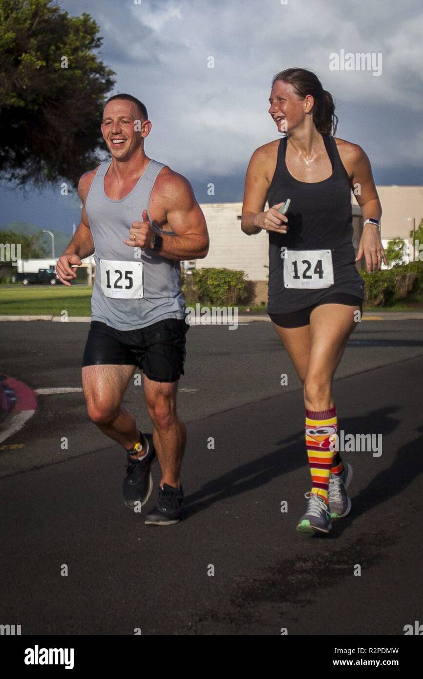 Contestants run during the Turkey Trot 5k and 10k run, Marine Corps Base Hawaii, Nov. 3, 2018. The event, hosted by 3rd Radio Battalion and Marine Corps Community Services Hawaii, is an annual Thanksgiving-themed event that is open to U.S. Service members, their families, and civilian participants. The event promotes readiness and resiliency across the installation and local community by encouraging healthy, family-oriented activity. Stock Photo