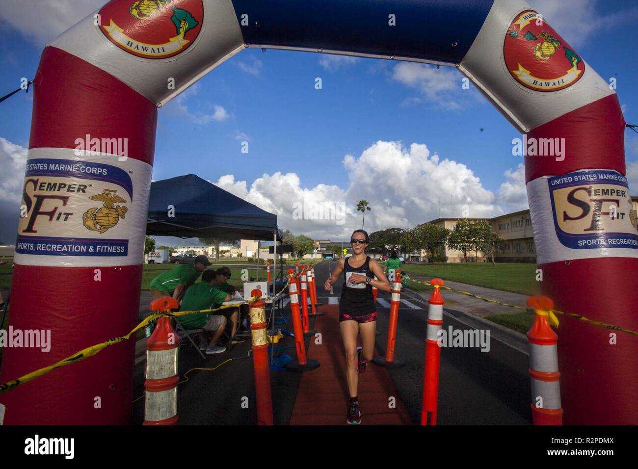 A contestant crosses the finish line during the Turkey Trot 5k and 10k run, Marine Corps Base Hawaii, Nov. 3, 2018. The event, hosted by 3rd Radio Battalion and Marine Corps Community Services Hawaii, is an annual Thanksgiving-themed event that is open to U.S. Service members, their families, and civilian participants. The event promotes readiness and resiliency across the installation and local community by encouraging healthy, family-oriented activity. Stock Photo