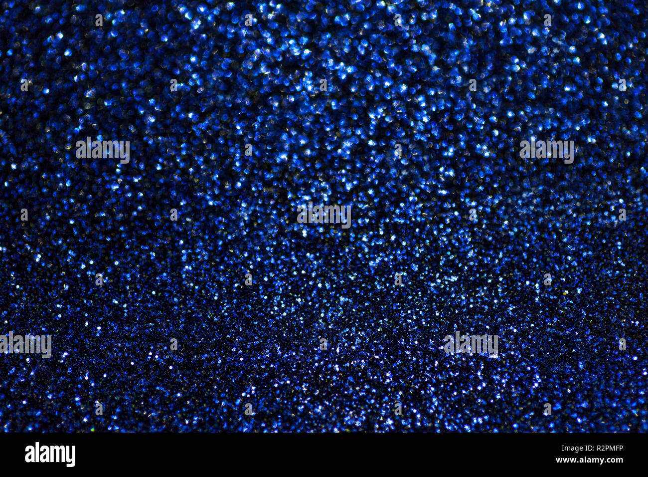 Dark navy blue sparkling background from small sequins, closeup. Brilliant shiny backdrop from textile. Shimmer paper Stock Photo
