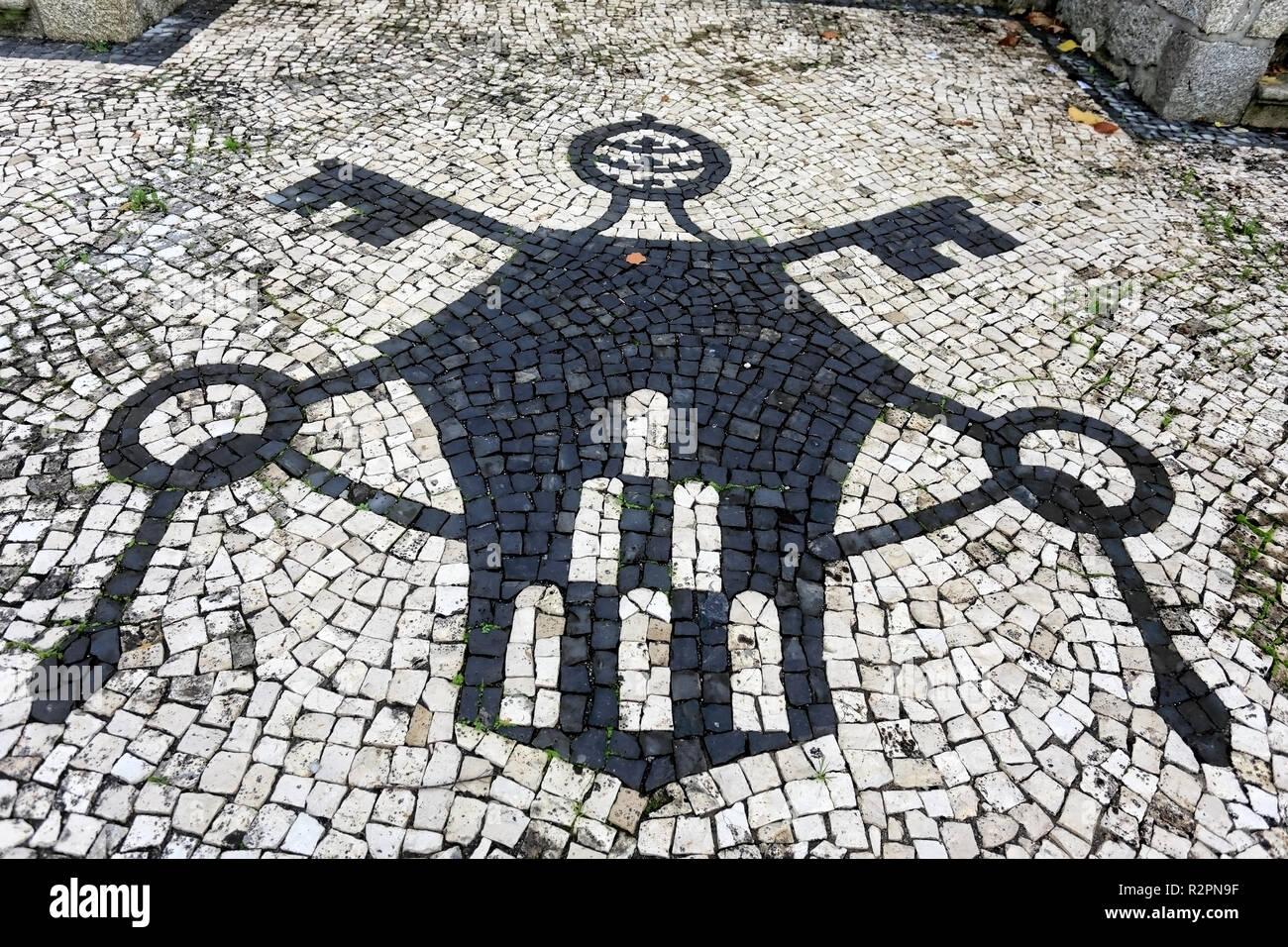 Part of the backyard floor of a northern church in Portugal with christian symbols. Portuguese pavement style, a traditional-style pavement used in pe Stock Photo