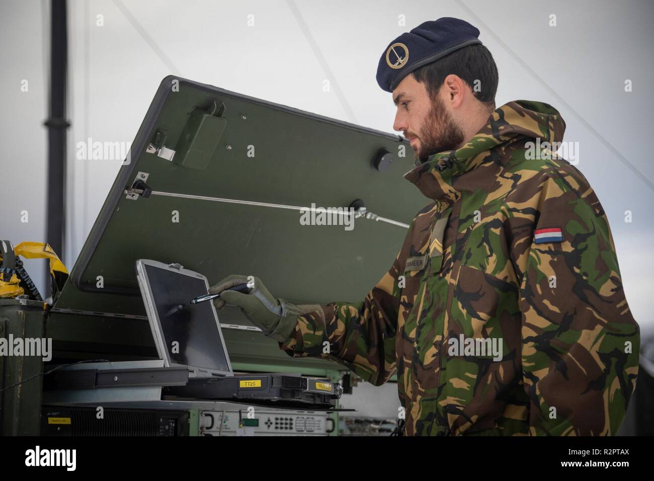 Dutch Sergeant Noordermeer checking the RACE 1 equipment. 1 German/Netherlands Corps' Communication and Information Systems Battalion is responsible for the communication between the Headquarters and its brigades. RACE 1 provides the CIS link between 1GNC as LCC and the Italian Ariete Brigade for Exercise Trident Juncture.    With around 50,000 personnel participating in Trident Juncture 2018, it is one of the largest NATO exercises in recent years. Around 250 aircraft, 65 vessels and more than 10,000 vehicles are involved in the exercise in Norway. Stock Photo